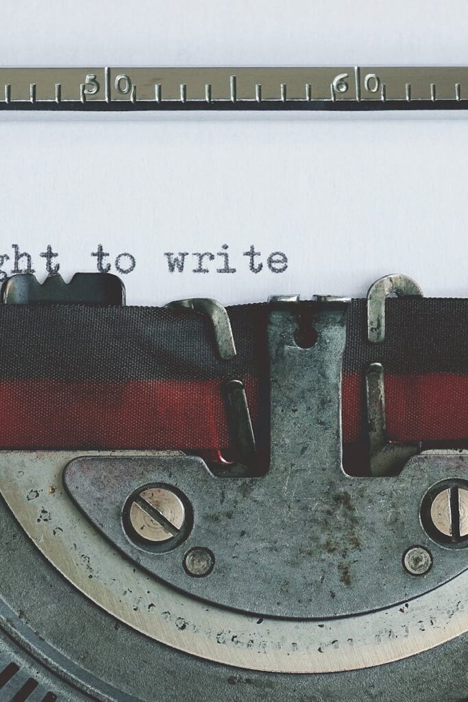 Close-up of a vintage typewriter with 'the right to write' typed on paper.
